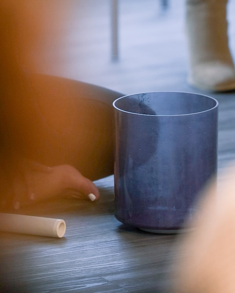 A sound bowl and its mallet on the floor during one of Tina’s sessions